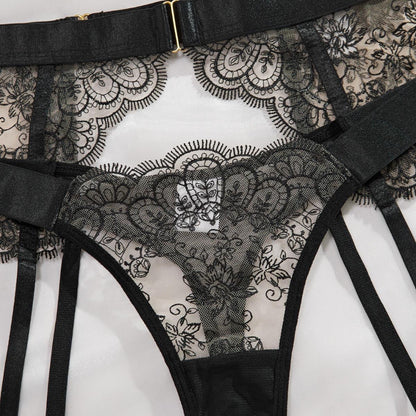 Capri Lace Lingerie Set with floral lace bra, thong and suspender belt displayed flat.