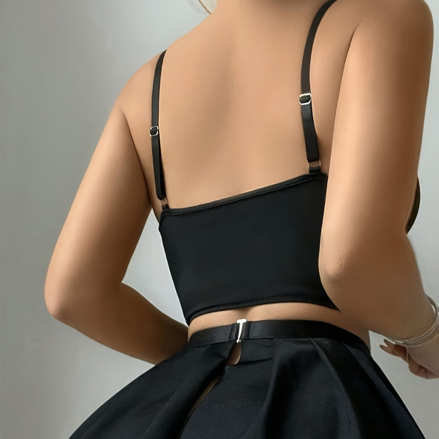 Lace-detailed French maid style lingerie set with black bralette, mini apron skirt and ribbon accessories.